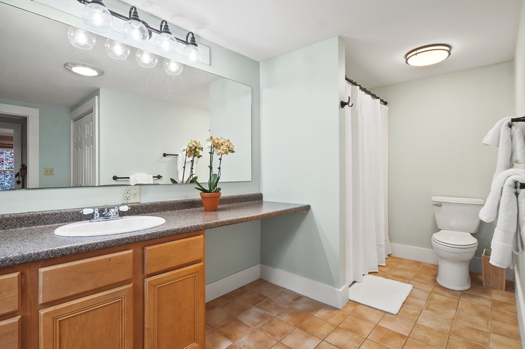 4 Winter Street, Unit 4 Amesbury, MA 01913 - Photo 22 of 39 a bathroom with a sink and a mirror
