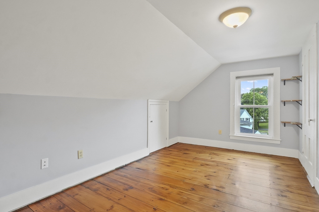4 Winter Street, Unit 4 Amesbury, MA 01913 - Photo 24 of 39 an empty room with wooden floor and windows
