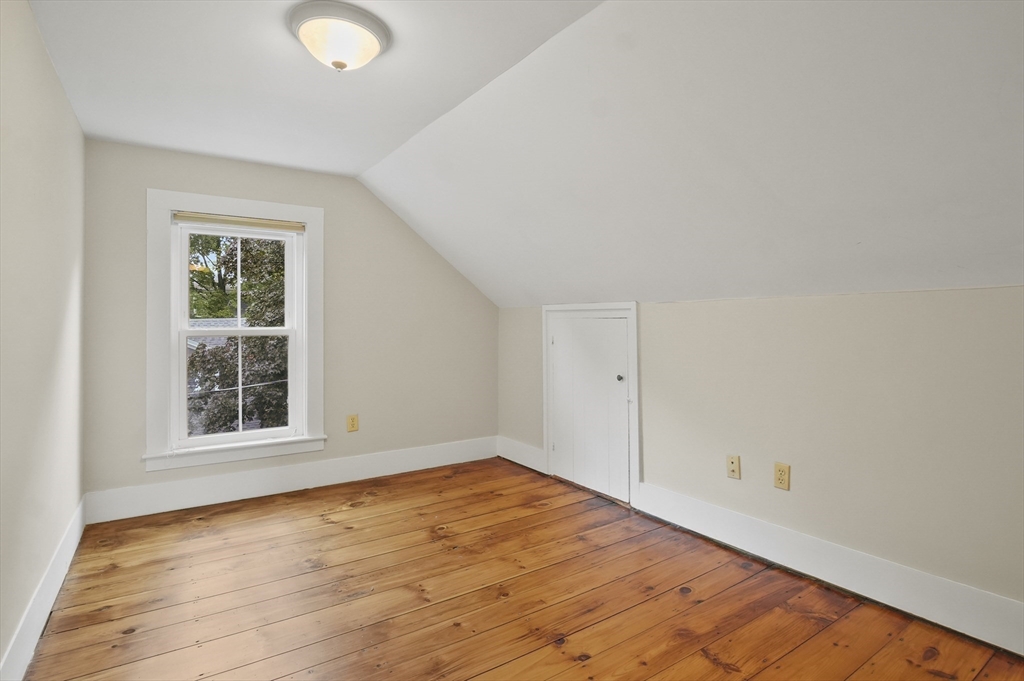 4 Winter Street, Unit 4 Amesbury, MA 01913 - Photo 26 of 39 an empty room with wooden floor and windows