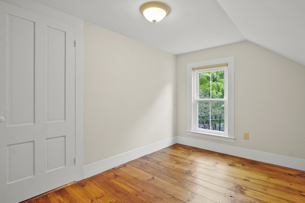 4 Winter Street, Unit 4 Amesbury, MA 01913 - Photo 27 of 39 an empty room with wooden floor and windows