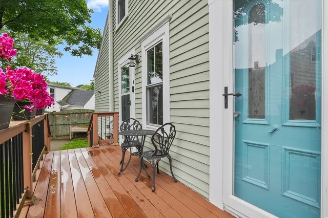 a balcony with table and chairs