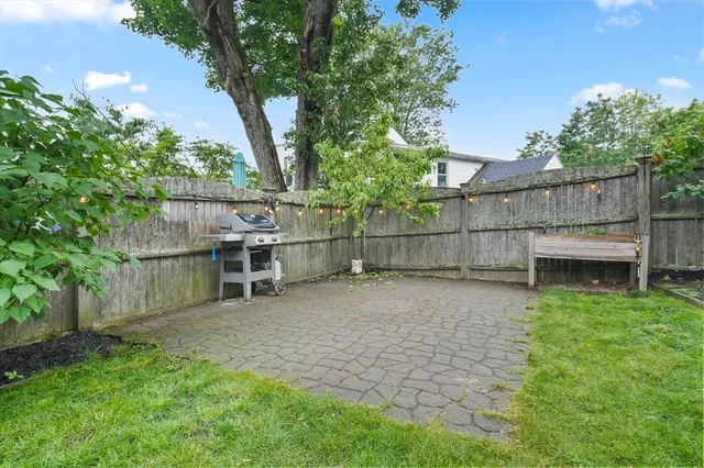 a view of backyard with seating and trees