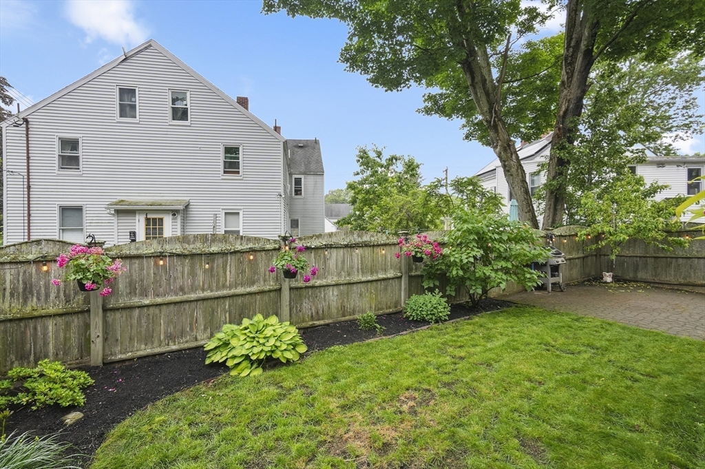 4 Winter Street, Unit 4 Amesbury, MA 01913 - Photo 34 of 39 a backyard of a house with lots of green space and plants