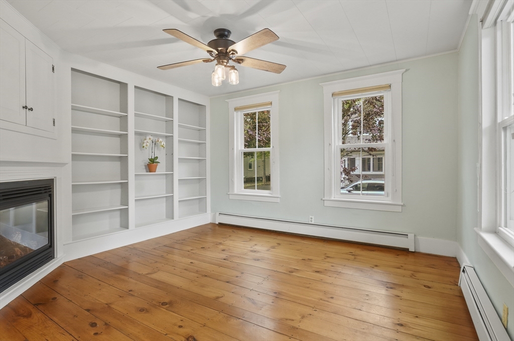4 Winter Street, Unit 4 Amesbury, MA 01913 - Photo 5 of 39 a view of an empty room with a window and fireplace