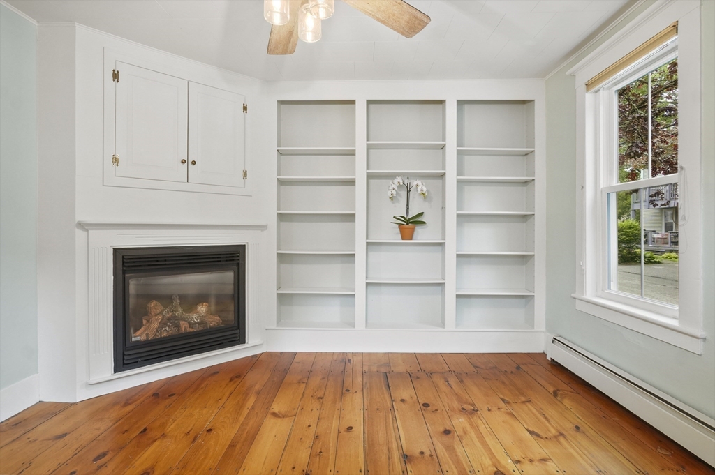 4 Winter Street, Unit 4 Amesbury, MA 01913 - Photo 7 of 39 a view of an empty room with a fireplace and a window