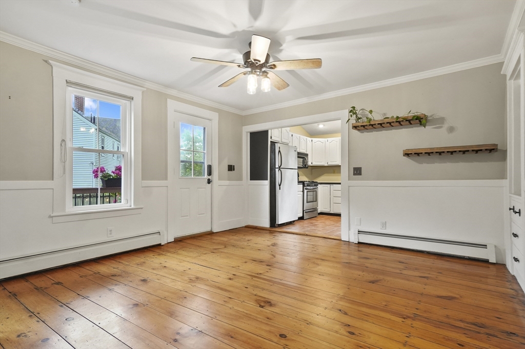 4 Winter Street, Unit 4 Amesbury, MA 01913 - Photo 9 of 39 a view of a kitchen with wooden floor and a ceiling fan