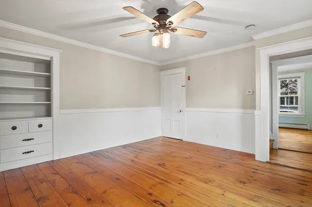 a view of a room with cabinet and ceiling fan