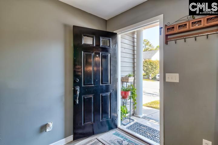 209 Eagle Pointe Drive Chapin, SC 29036 - Photo 5 of 40 a view of a hallway with wooden floor and a dining room