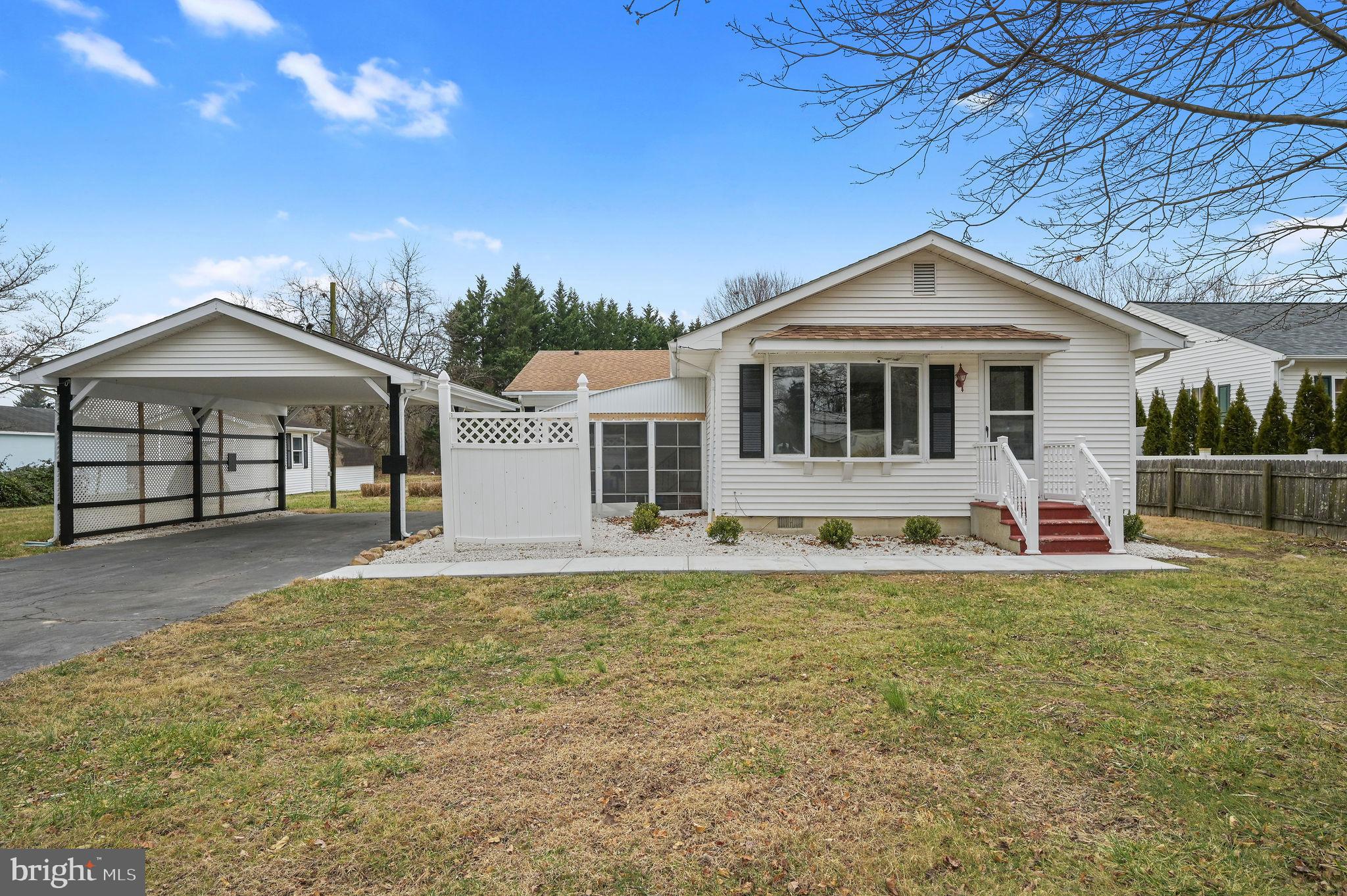 2891 Kenton Road Dover, DE 19904 - Photo 1 of 18 a front view of a house with a yard and garage