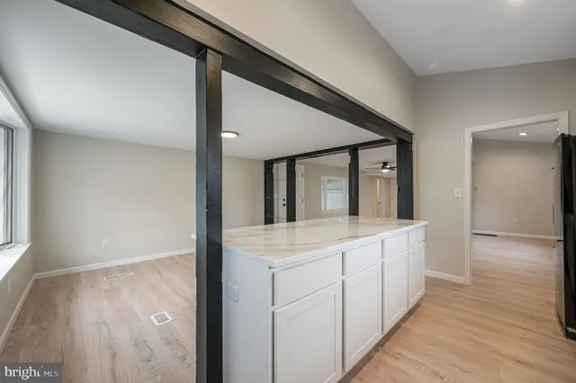 a view of hallway with wooden floor