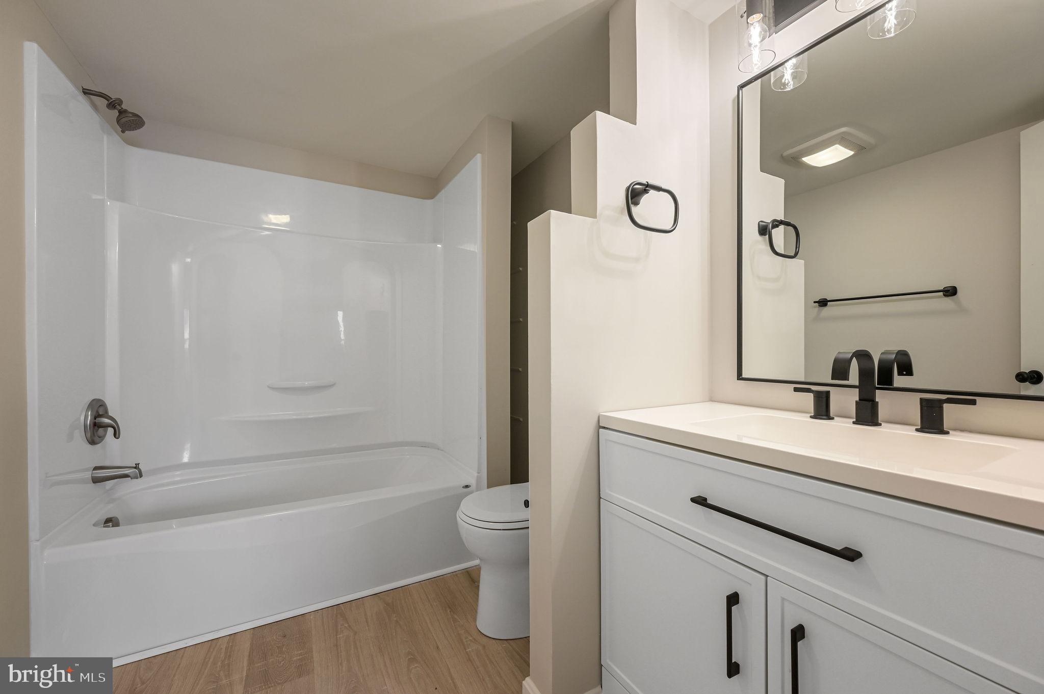 2891 Kenton Road Dover, DE 19904 - Photo 18 of 18 a bathroom with a bathtub shower sink vanity and toilet