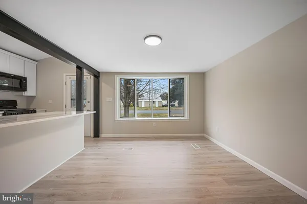 a view of a kitchen with microwave and windows