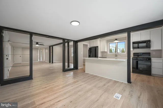 a view of a kitchen with wooden floor and a kitchen