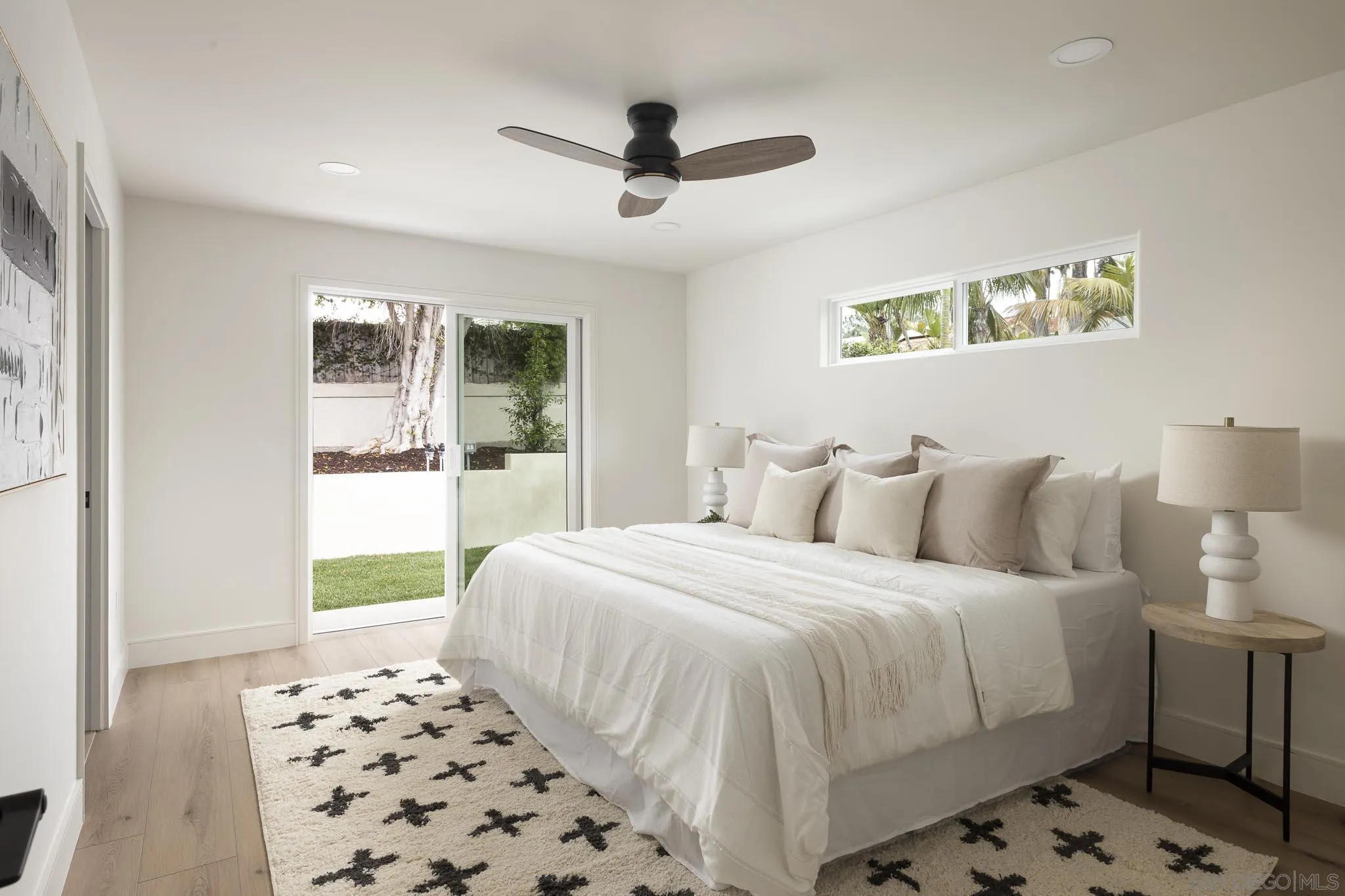 614 Ezee Street Encinitas, CA 92024 - Photo 15 of 46 a bedroom with a bed and a lamp next to a window