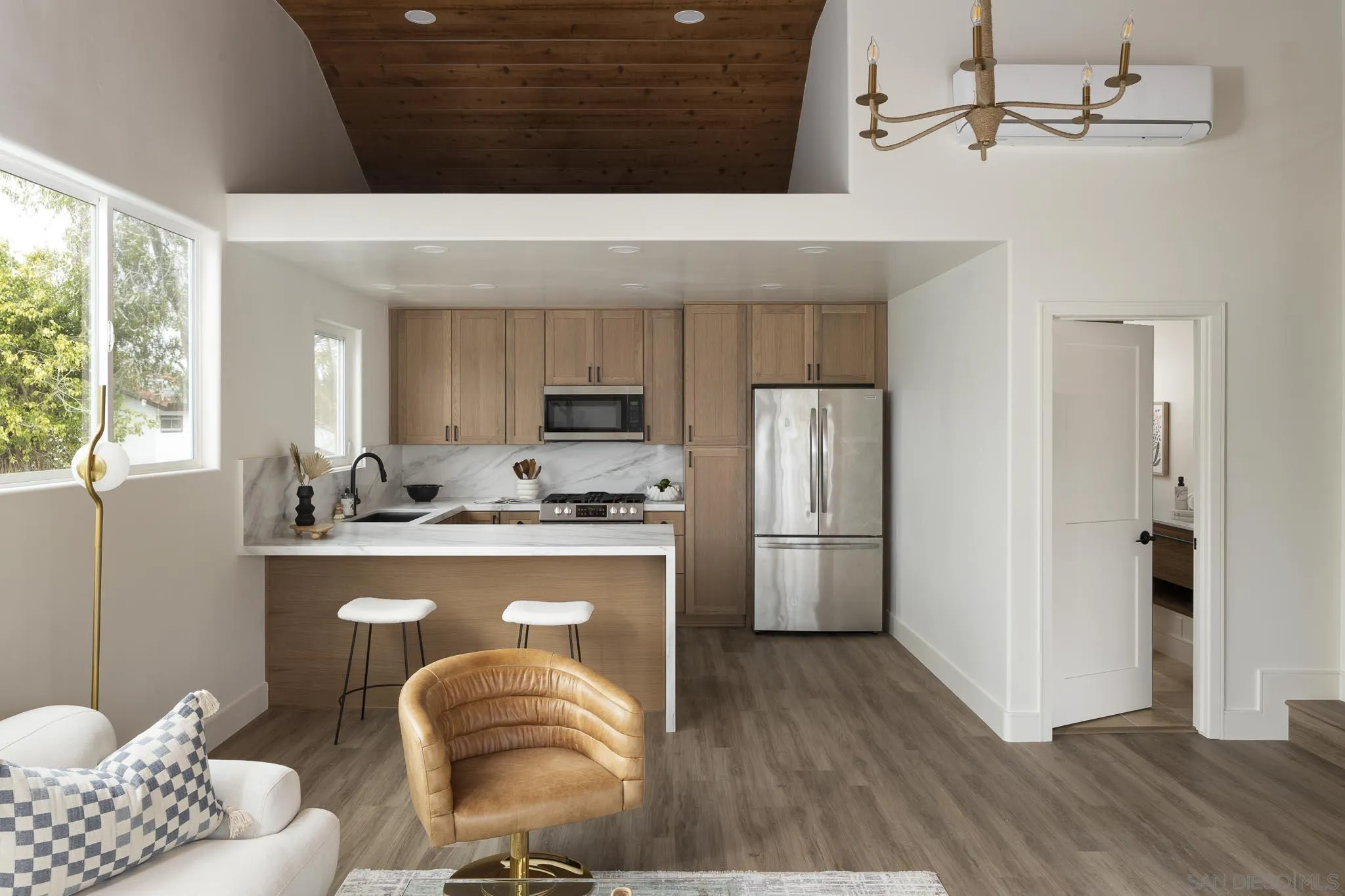 614 Ezee Street Encinitas, CA 92024 - Photo 30 of 46 a kitchen with stainless steel appliances granite countertop a refrigerator a stove a sink dishwasher and a dining table with wooden floor