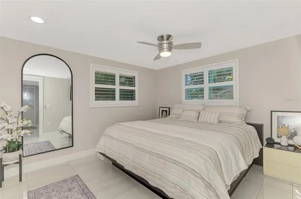 a bedroom with a large bed and a window