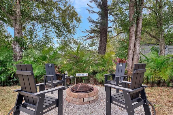 a view of a chairs and table in backyard