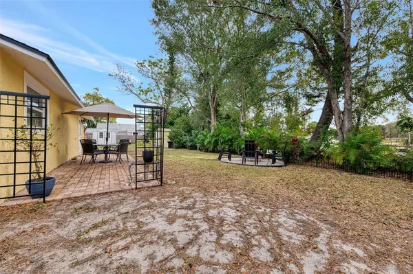 a view of a house with backyard and sitting area
