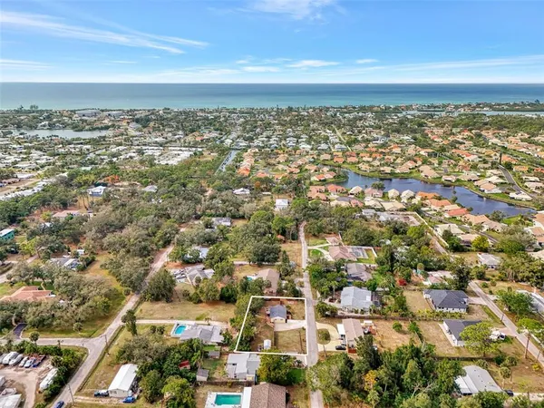 an aerial view of residential building and ocean