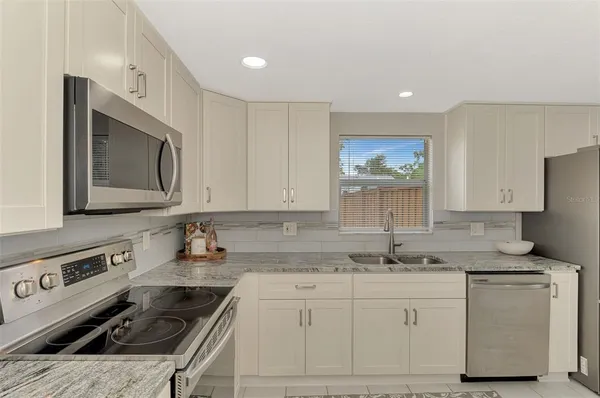 a kitchen that has a sink and a stove