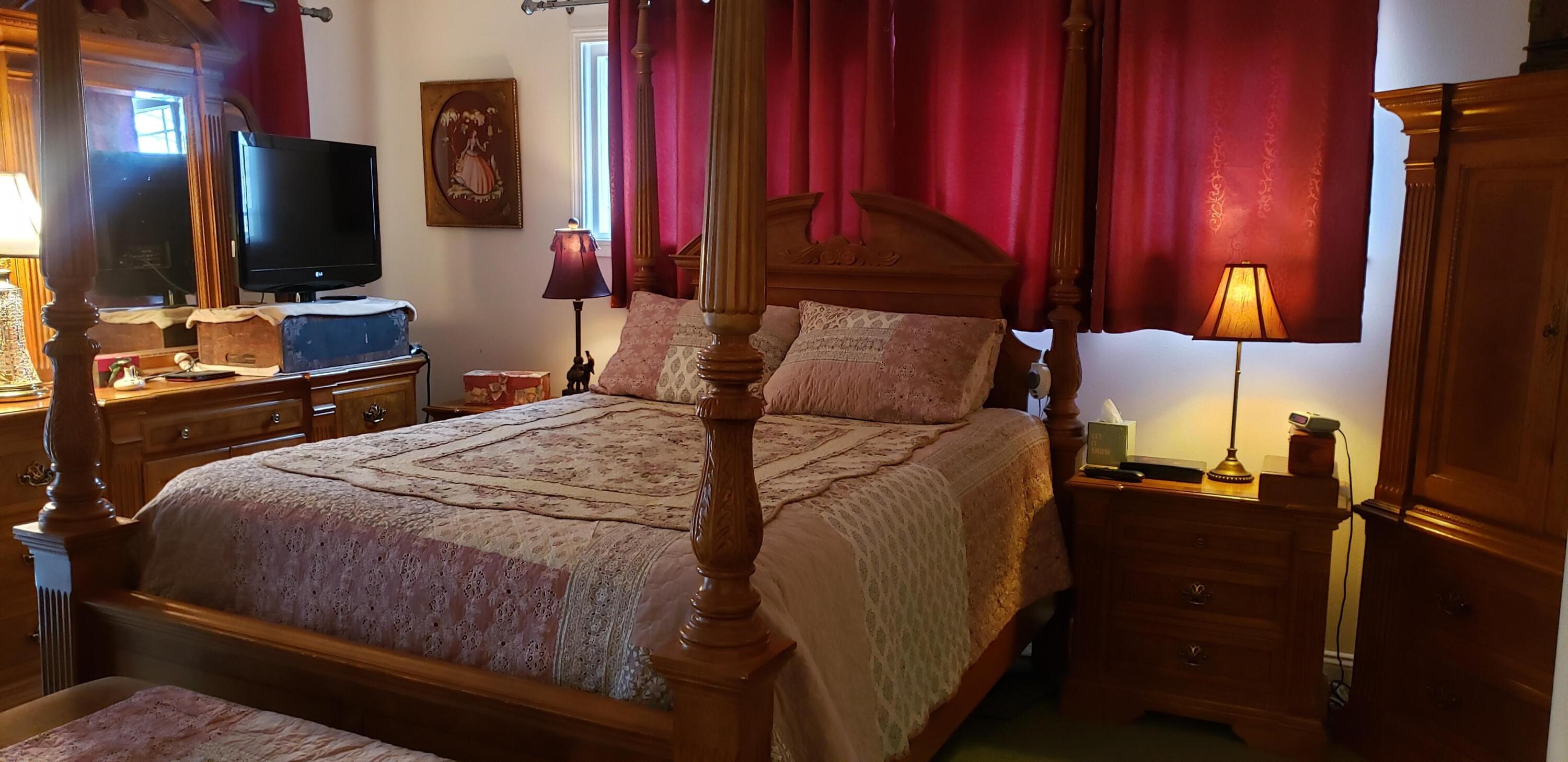 24924 Curve Street Fall River Mills, CA 96028 - Photo 12 of 25 a bedroom with a bed tv and a flat screen tv