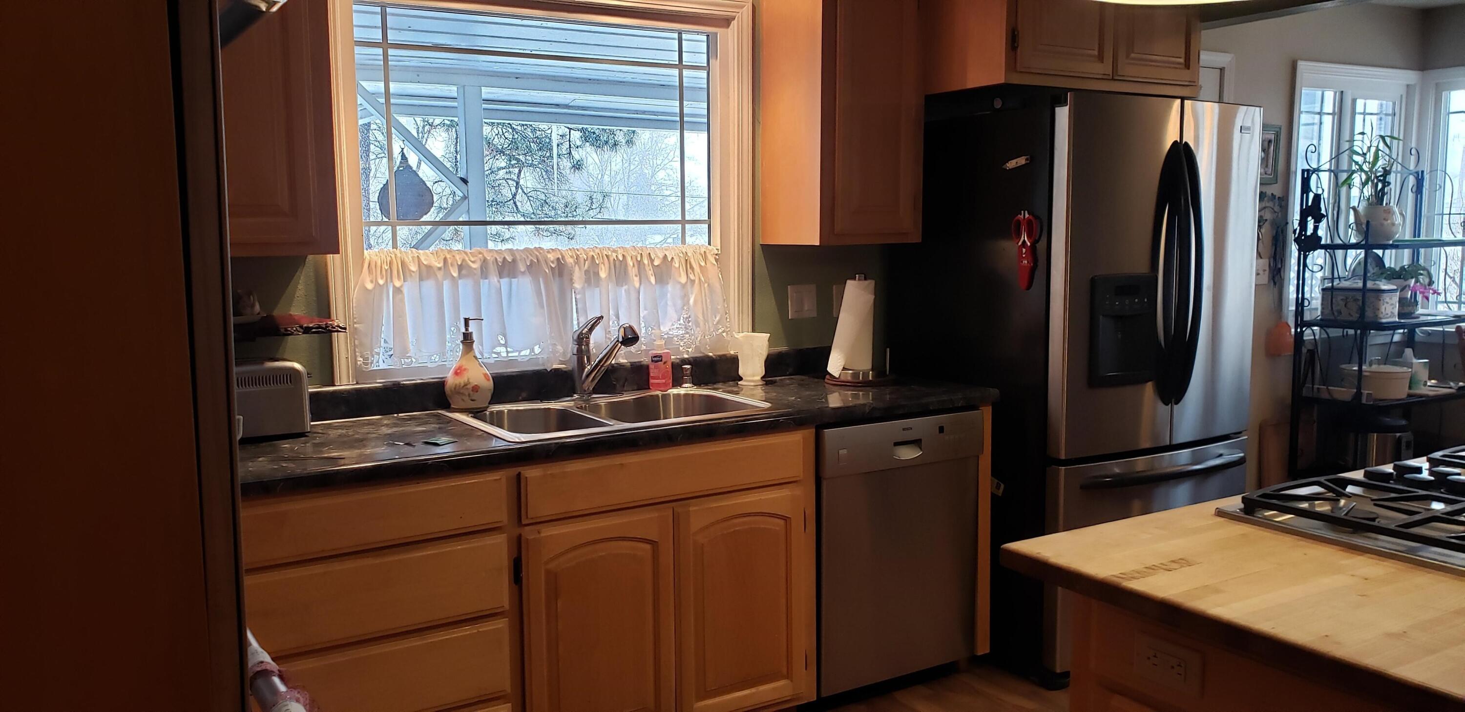 24924 Curve Street Fall River Mills, CA 96028 - Photo 2 of 25 a kitchen with stainless steel appliances a sink stove and refrigerator