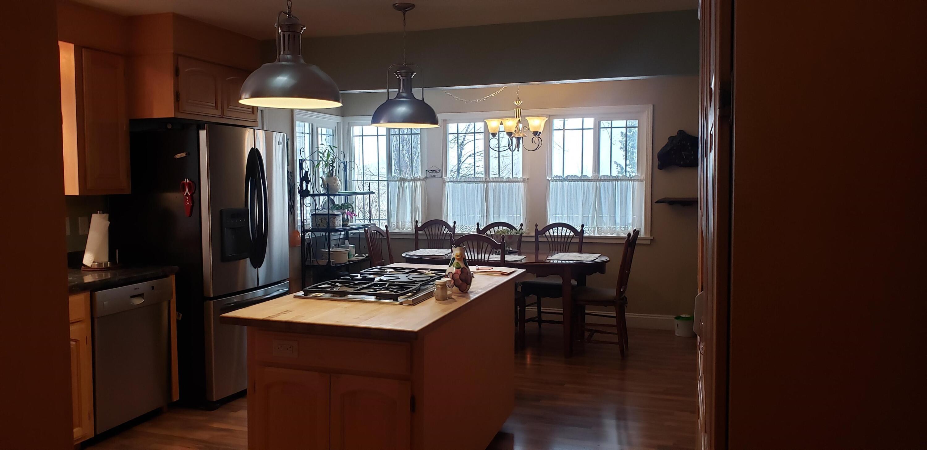 24924 Curve Street Fall River Mills, CA 96028 - Photo 3 of 25 a kitchen with a table chairs refrigerator and cabinets