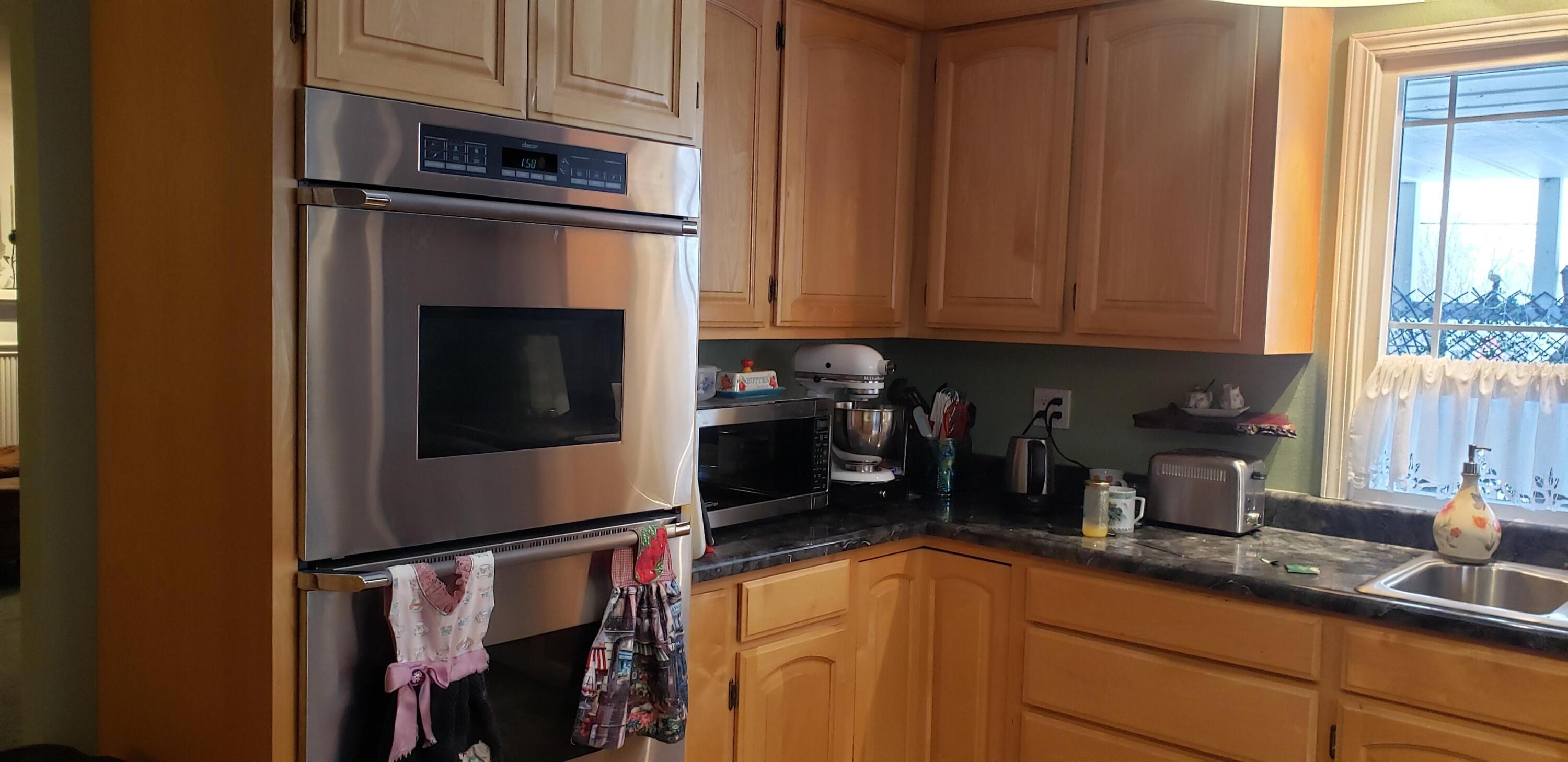 24924 Curve Street Fall River Mills, CA 96028 - Photo 6 of 25 a kitchen with stainless steel appliances granite countertop a refrigerator and a sink