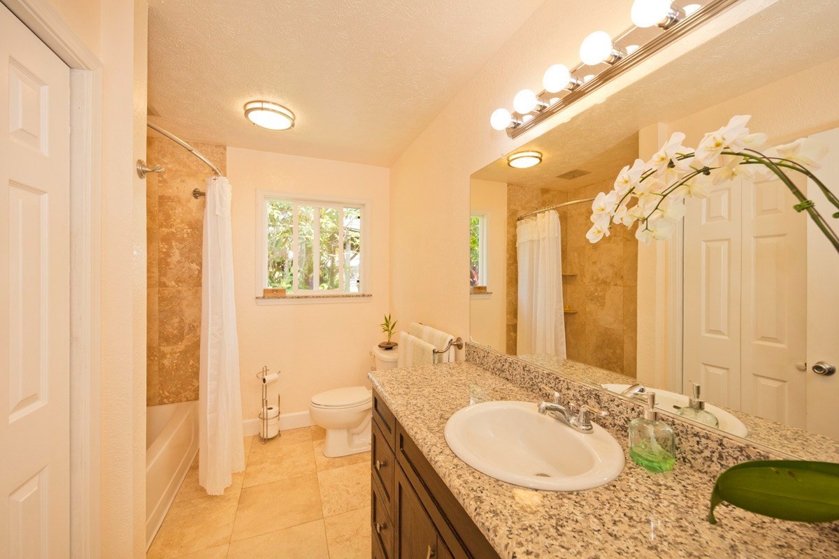 20 Hoaka Road Hilo, HI 96720 - Photo 14 of 30 a bathroom with a granite countertop sink and a mirror