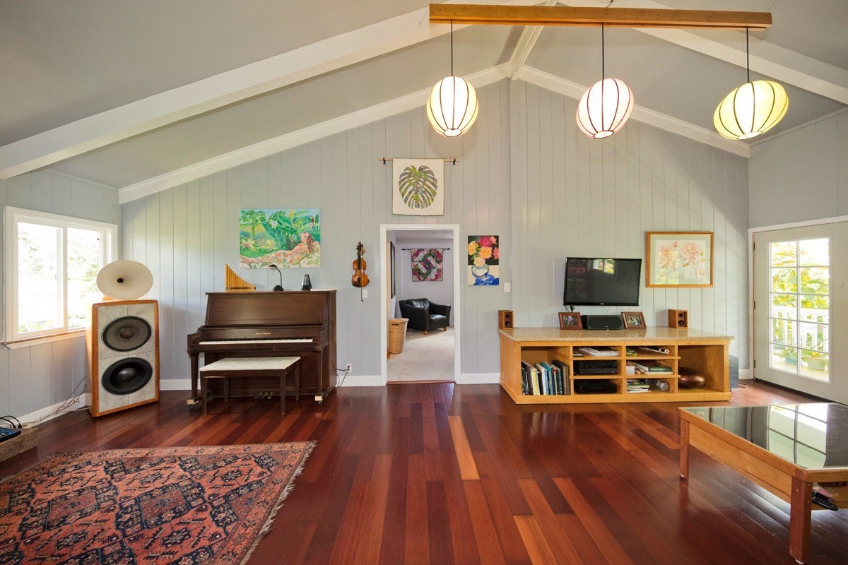 20 Hoaka Road Hilo, HI 96720 - Photo 7 of 30 a view of a livingroom with furniture a flat screen tv wooden floor and a window