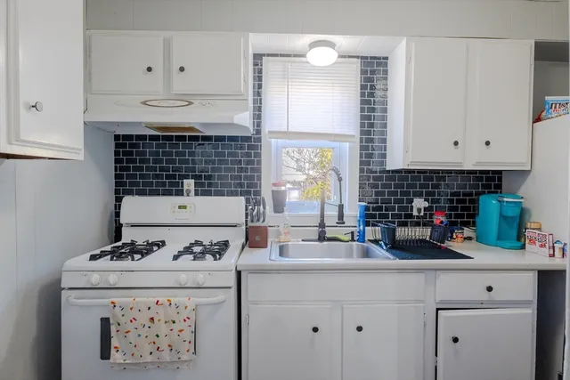 a bedroom with a bed and windows