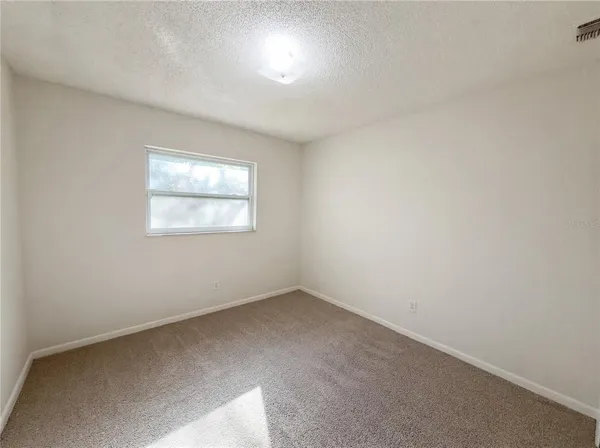 a bathroom with a granite countertop sink a mirror and a bathtub