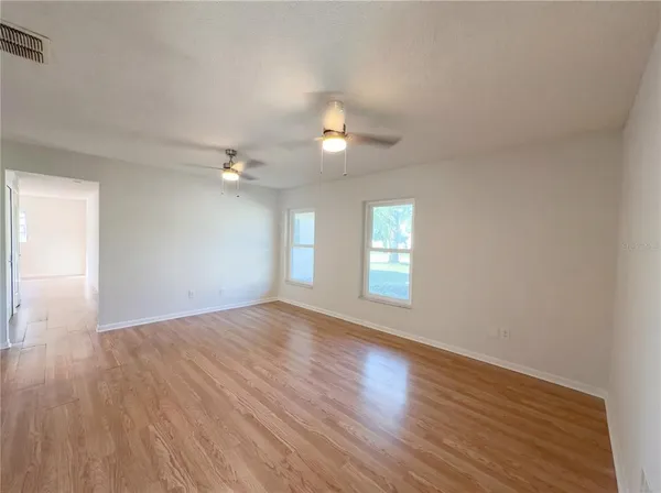 a large kitchen with stainless steel appliances and a refrigerator