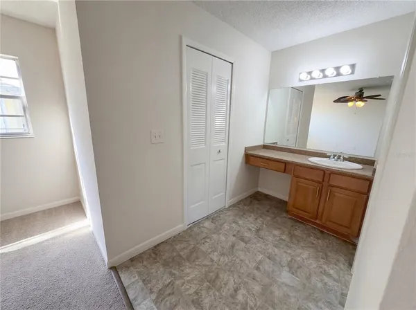 a bathroom with a granite countertop sink toilet and mirror
