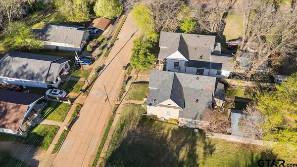 an aerial view of residential houses with outdoor space