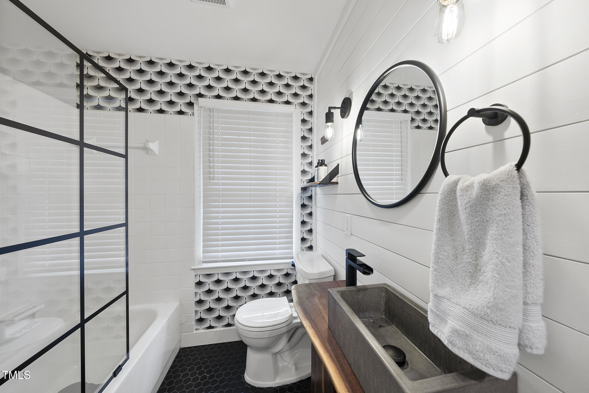 1533 North King Charles Road Raleigh, NC 27610 - Photo 33 of 41 a bathroom with a sink a mirror a toilet and a shower