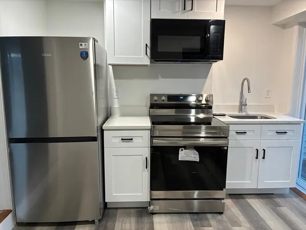 a kitchen with stainless steel appliances a refrigerator stove and microwave