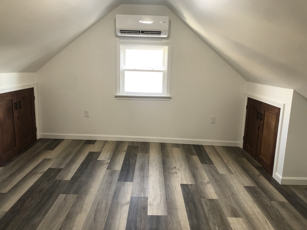 57 Bloomingdale Street, Unit 1 Chelsea, MA 02150 - Photo 8 of 9 a view of an empty room with wooden floor and a window
