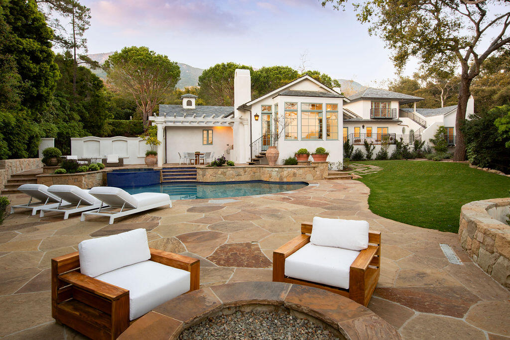 1839 East Mountain Drive Montecito, CA 93108 - Photo 2 of 24 a front view of a house with garden and chairs