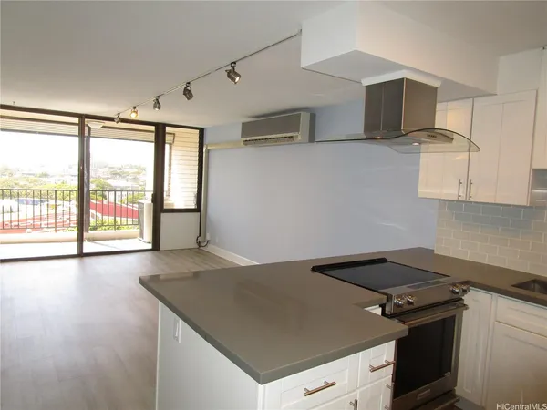 a view of a kitchen with a sink and dishwasher next to a large window
