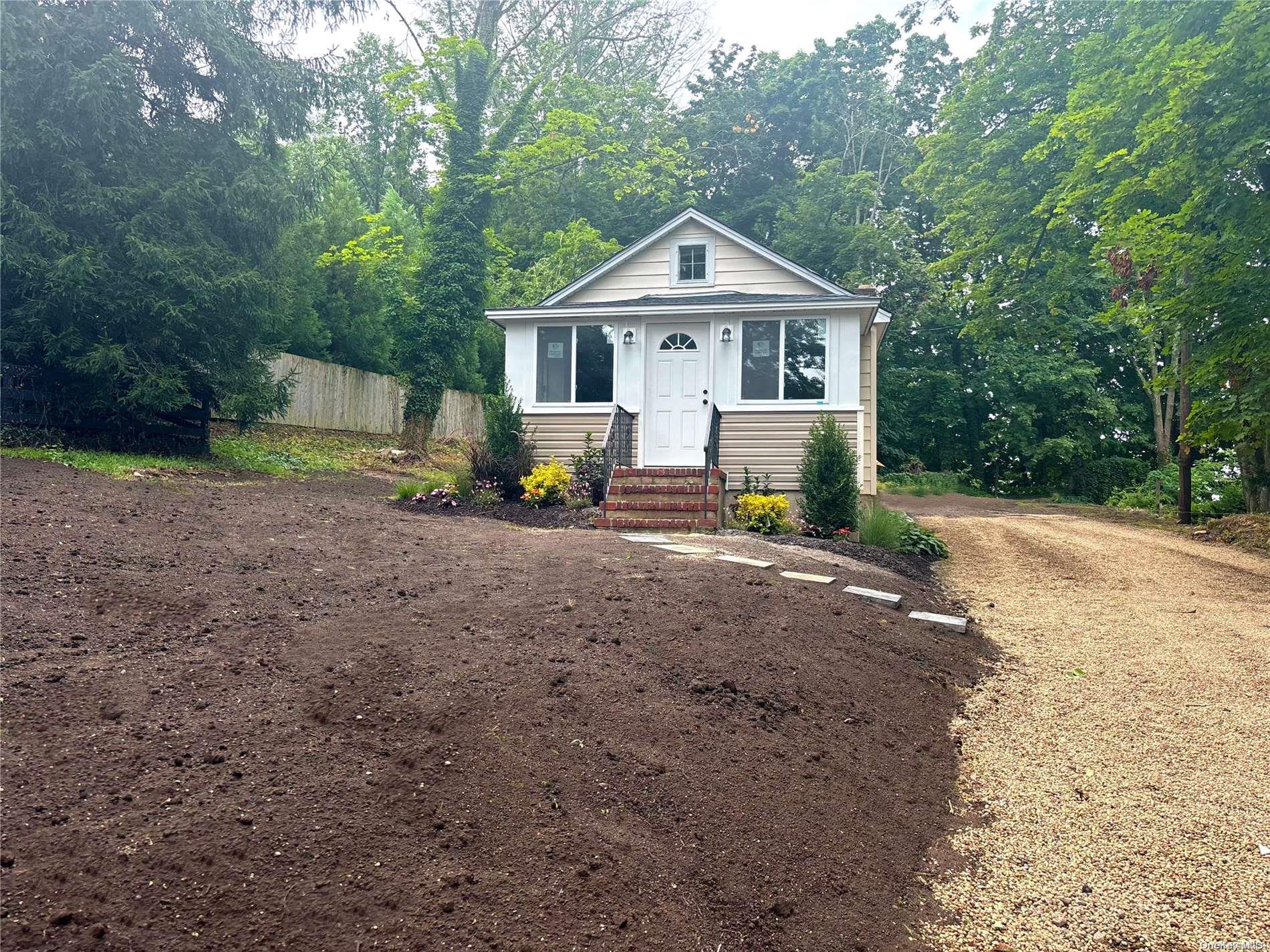 8 Poplar Place Cold Spring Harbor, NY 11724 - Photo 1 of 1 a front view of a house with a garden