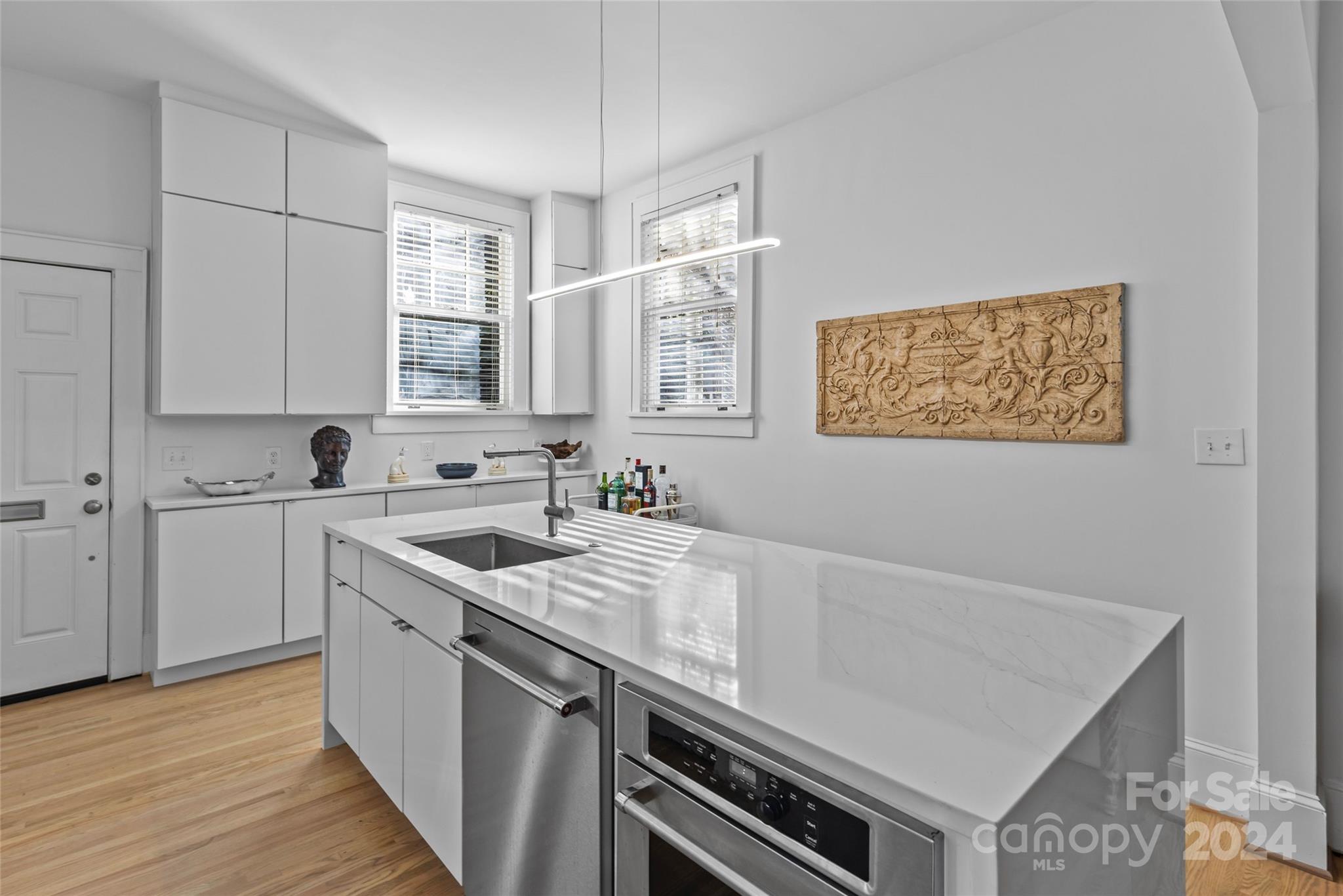 609 Queens Road, Unit A Charlotte, NC 28207 - Photo 14 of 33 a kitchen with stainless steel appliances granite countertop a sink stove and cabinets