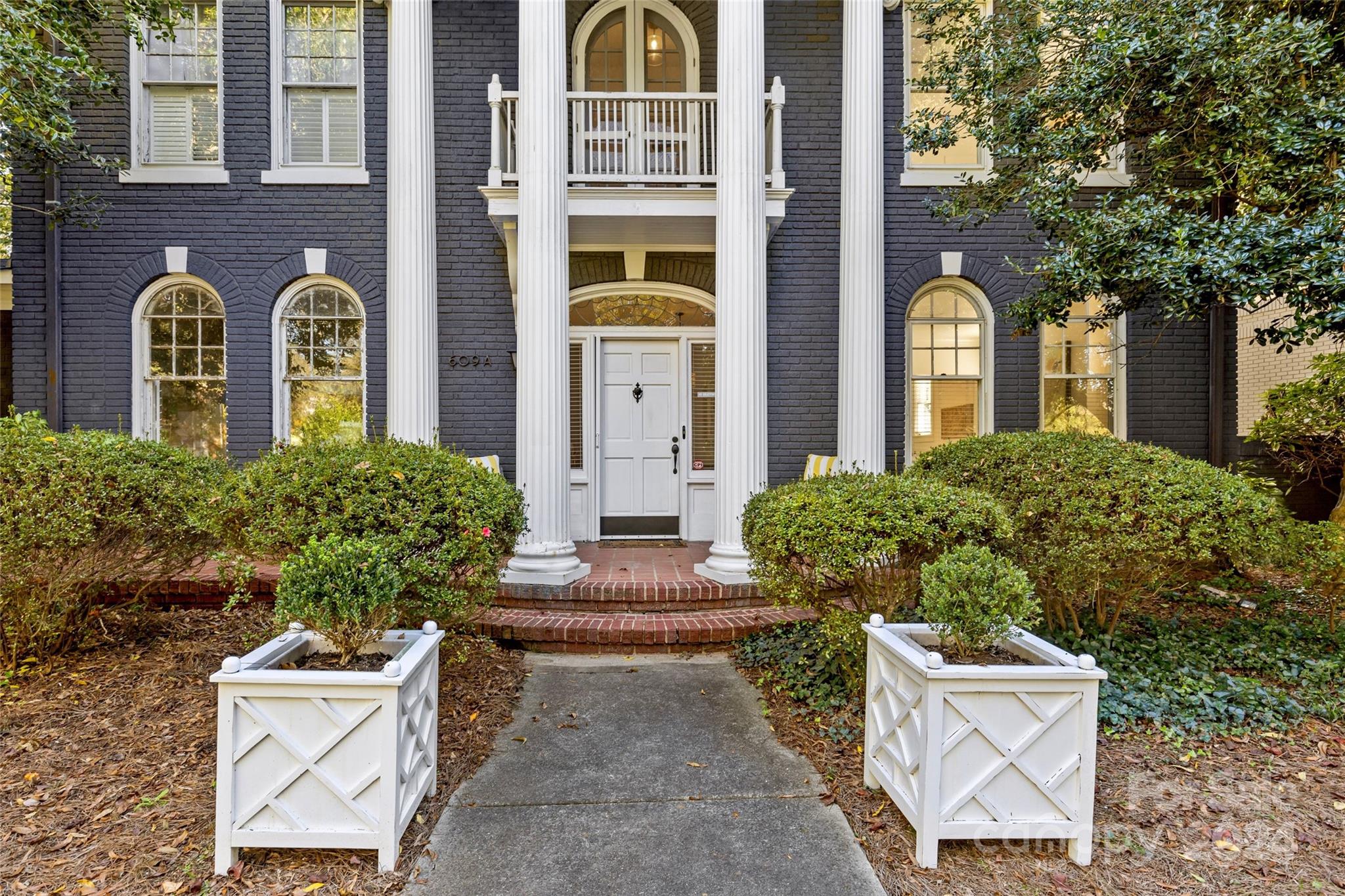 609 Queens Road, Unit A Charlotte, NC 28207 - Photo 3 of 33 a front view of a house with garden