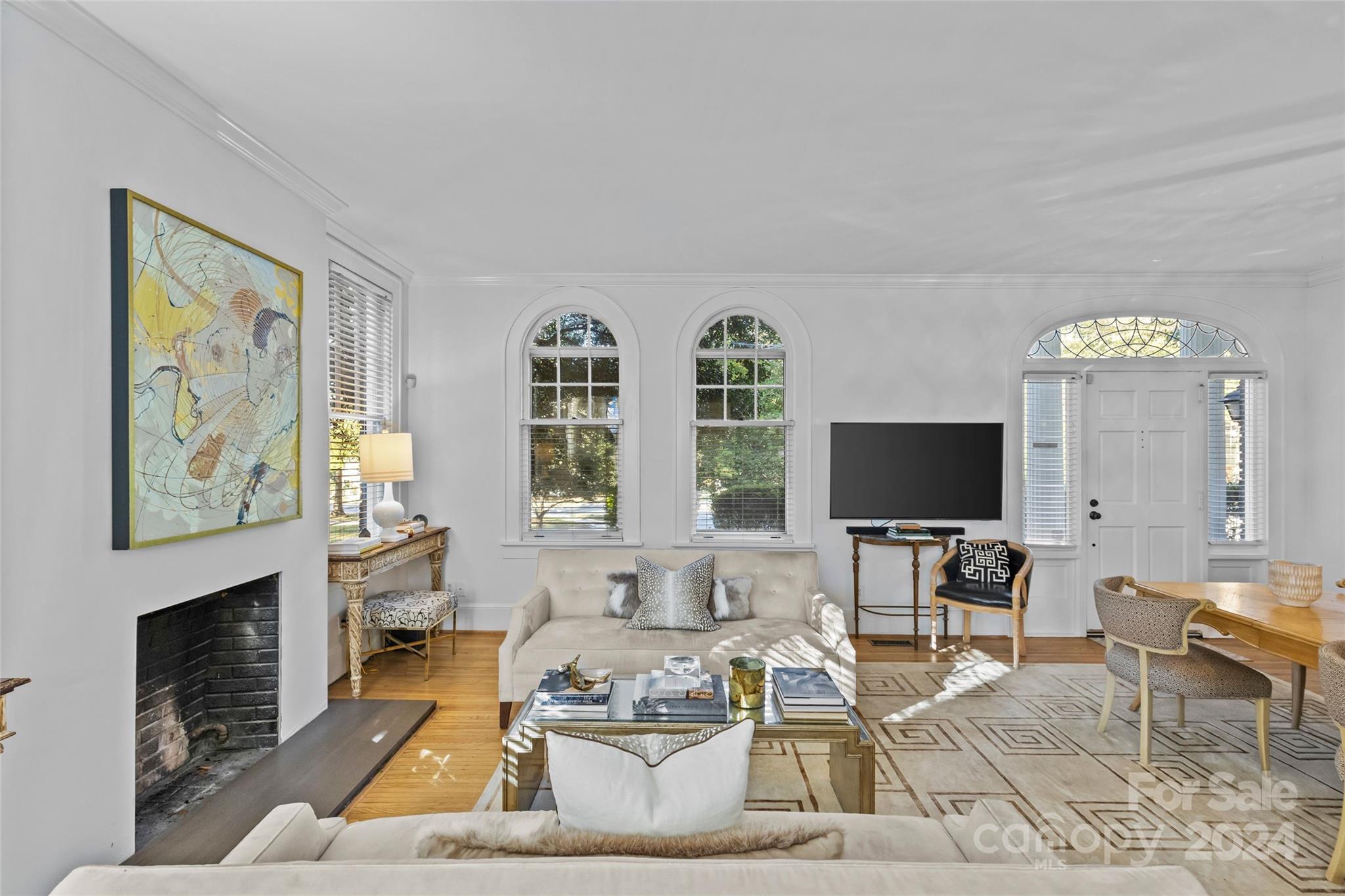 609 Queens Road, Unit A Charlotte, NC 28207 - Photo 8 of 33 a living room with furniture a flat screen tv and a fireplace