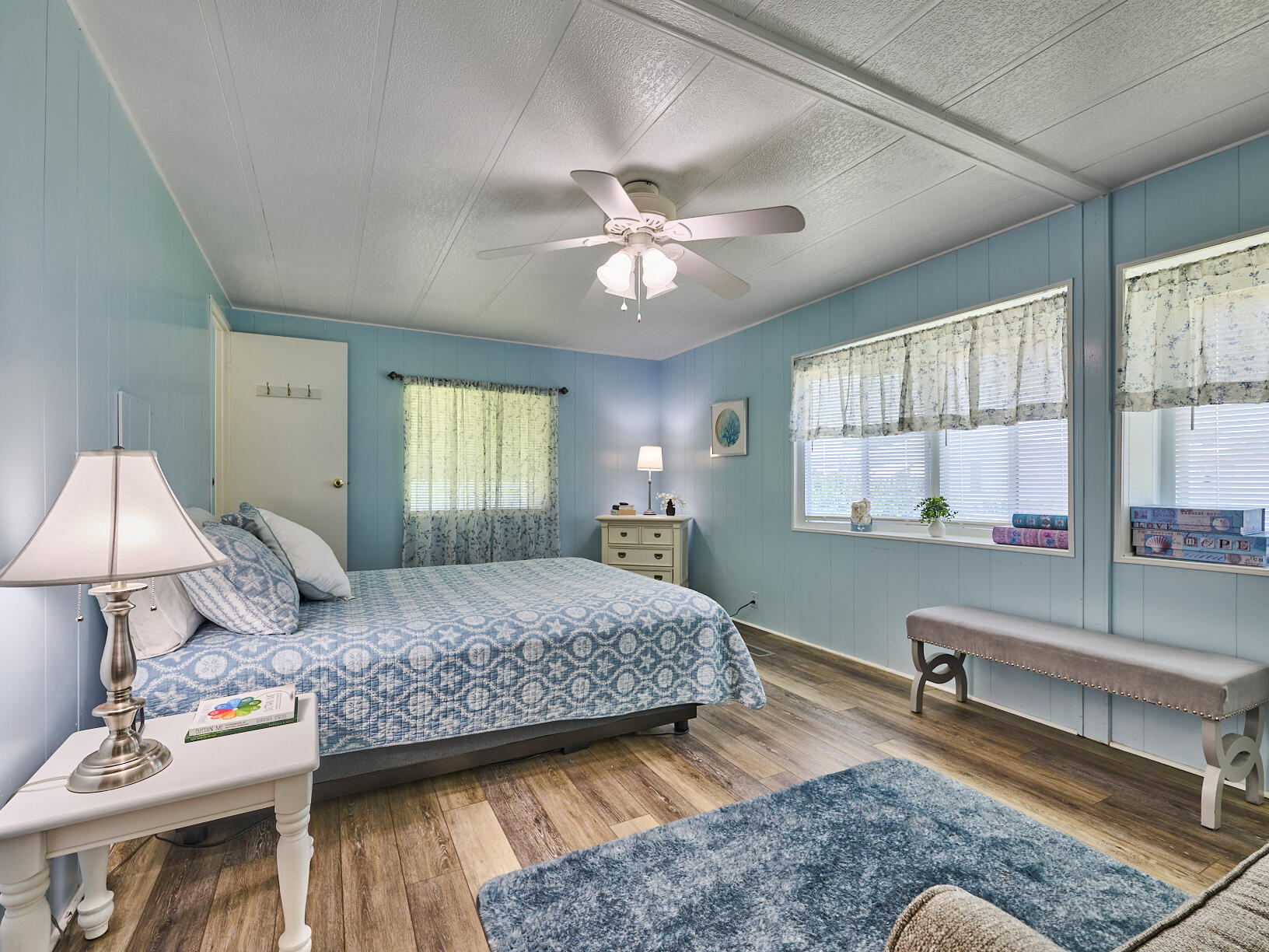 6977 Southeast Delegate Street Hobe Sound, FL 33455 - Photo 27 of 60 a bedroom with a large bed and a window
