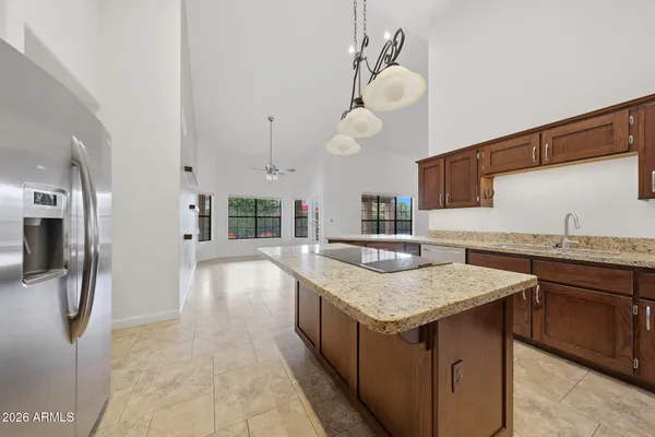 a kitchen with granite countertop a sink and a stove