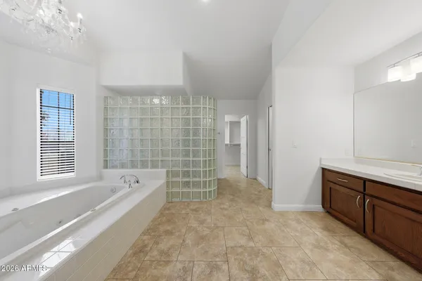 a bathroom with a granite countertop toilet and a shower