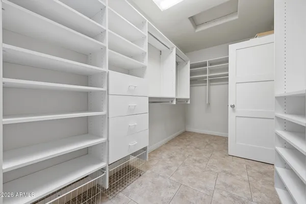 a view of walk in closet with empty racks