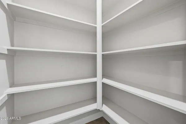 an empty room with windows and ceiling fan view