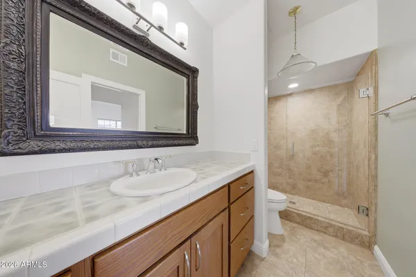 a bathroom with a sink mirror toilet and bathtub